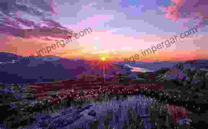 A Panoramic Vista Of A Mountain Range At Sunset, With Vibrant Clouds Casting A Warm Glow On The Peaks And Valleys. Light And Color In The Outdoors